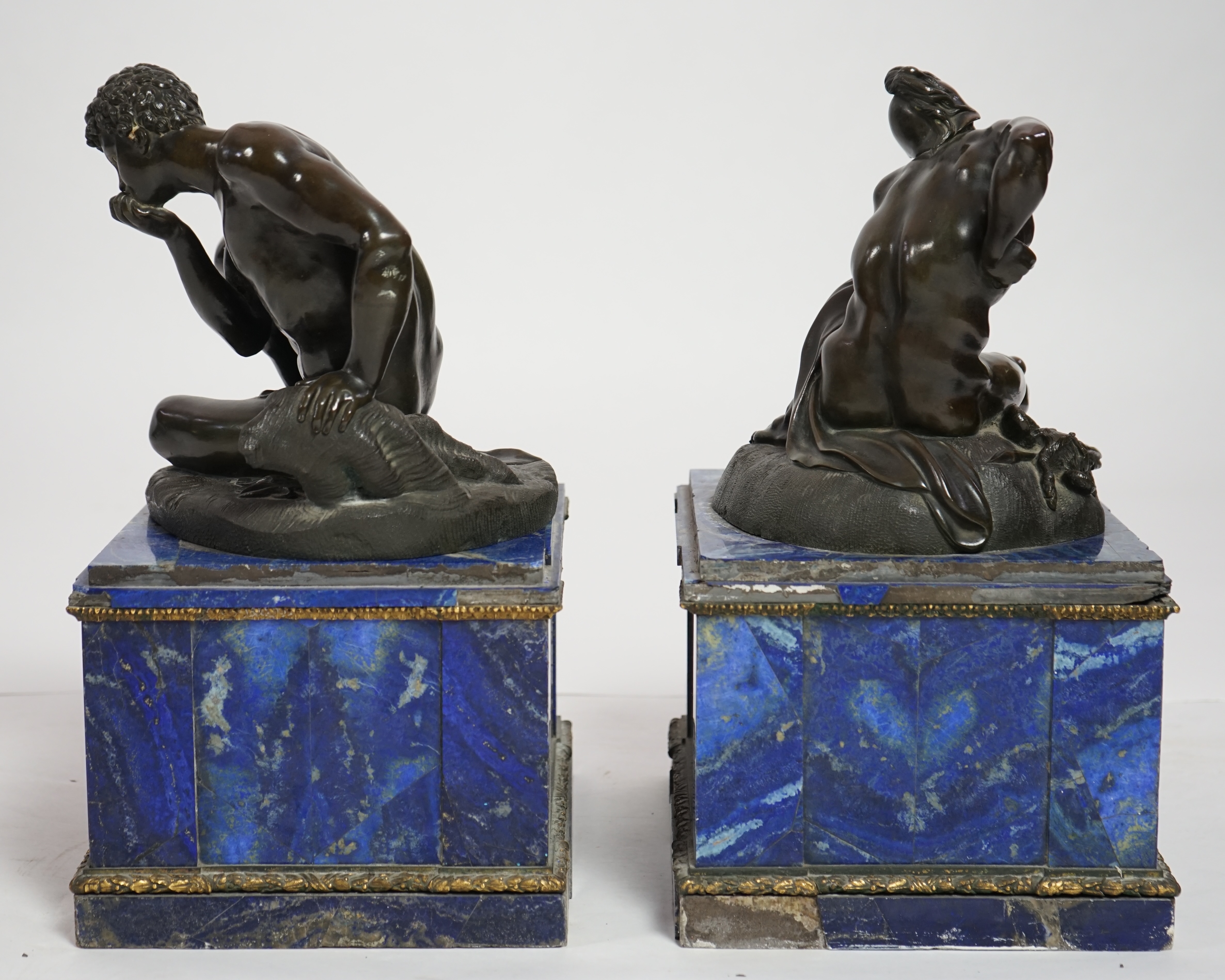 After the antique, a pair of late 18th/early 19th century Grand Tour souvenir bronze figures of seated warriors